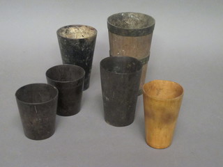 A wooden and metal beaker and 5 horn beakers