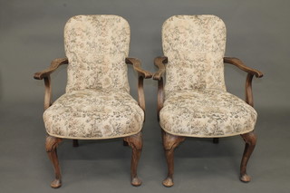A pair of Georgian style mahogany open arm chairs with  upholstered seats and backs raised on cabriole supports