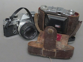 An Olympus OM-1N camera with Olympus OM-SystemF.Zuiko Auto-S1;1.8 F=50mm lens and a Balda folding camera