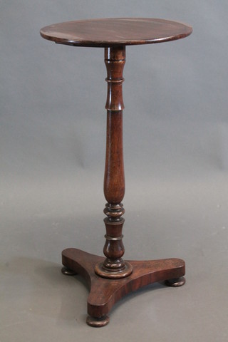 A William IV circular mahogany wine table, raised on a turned column with triform base 15"
