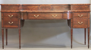 A Georgian mahogany sideboard, the raised back fitted cupboards above 1 long drawer flanked by 2 long drawers, raised on square  tapering supports ending in spade feet 88"