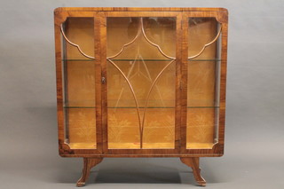 A 1930's Art Deco figured walnut display cabinet, the shelved interior enclosed by astragal glazed doors, raised on splayed feet  42 1/2"