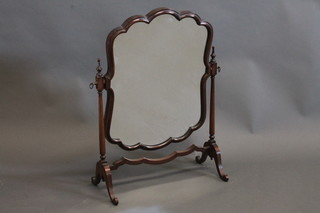 A shaped plate dressing table mirror contained in a mahogany  swing frame 14"