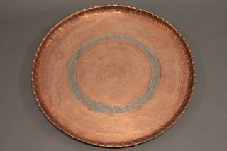 A circular embossed copper charger 29"
