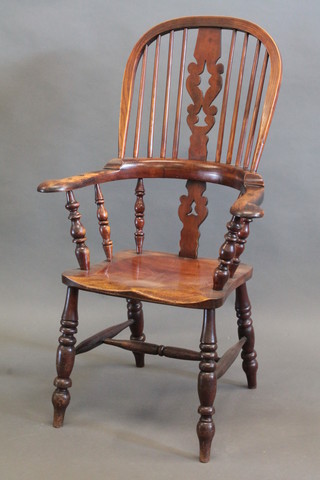 An 18th/19th Century elm stick back kitchen chair, raised on  turned supports