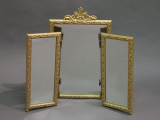 A rectangular bevelled plate triple dressing table mirror contained in a gilt frame