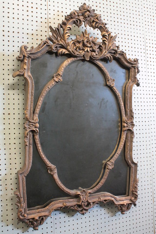 A plate mirror contained in a decorative gilt frame 22"