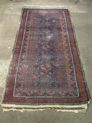 An Afghan rug with 8 octagons to the centre within multi-row borders, some wear 102" x 45"