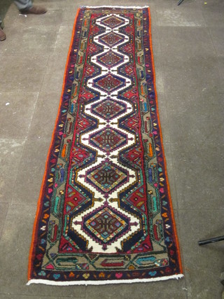 A multi coloured Eastern rug with 8 octagons to the centre, some  wear to the corner, 110" x 29 1/2"