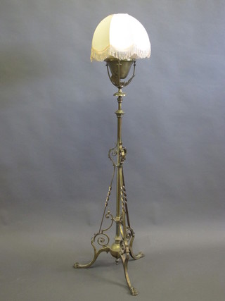 A brass adjustable oil lamp stand