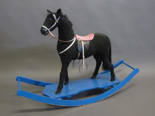 A rocking horse in the form of a standing black pony