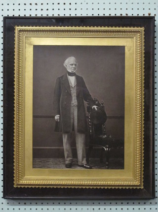 An early black and white photograph of a standing gentleman  wearing a top hat, contained in a decorative gilt frame 16" x 11  1/2"