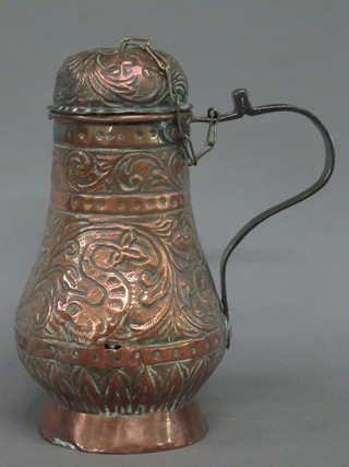 An Eastern embossed copper jug with iron handle 10"