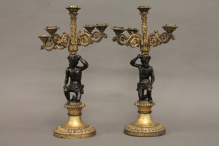 A handsome pair of 19th Century bronze and gilt ormolu 3 light candelabrum in the form of seated gentleman supporting 5 light  candelabrum and raised on circular spreading base 15 1/2"   ILLUSTRATED