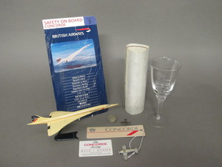 A plastic model of Concorde, a Concorde luggage label, a Concorde Society membership card, a Concorde Flights of Fancy  glass, do. Safety on Board card issue no.5, do. certificate, a  brooch in the form of a Spitfire, a WWII discharge badge and a  model of an aircraft