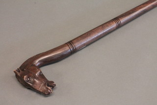A turned wooden walking stick, the handle carved a horses head,  ears f,