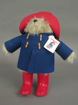 A Paddington Bear with red boots and blue duffel coat
