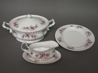 A 40 piece Royal Albert Lavender Rose pattern dinner service comprising twin handled sauce tureen 11", pair of circular twin  handled vegetable tureens 9", an oval meat plate 14", 8 dinner  plates 10 1/2", 8 breakfast plates 8", 8 side plates 6 1/2", sauce  boat and stand, salt and pepper pot, 8 pudding bowls 5" - 1  cracked,