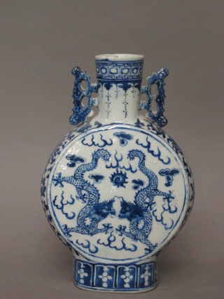 An Oriental blue and white twin handled moon flask decorated dragons, the base with 4 character mark 10"