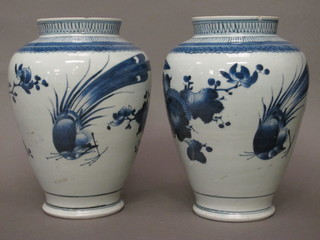 A pair of Oriental blue and white porcelain vases decorated  flowers and fabulous birds 9"