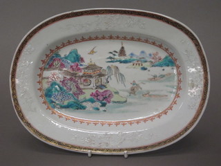 An Oriental oval porcelain dish decorated temples, lake etc 9"