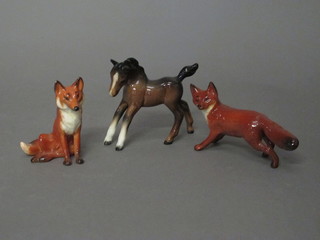 A Beswick figure of a bay foal 3" and 2 Beswick figures of a seated and running fox 4" and 6"