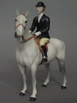 A Beswick figure of a lady huntswoman with black coat and  bowler hat 8"