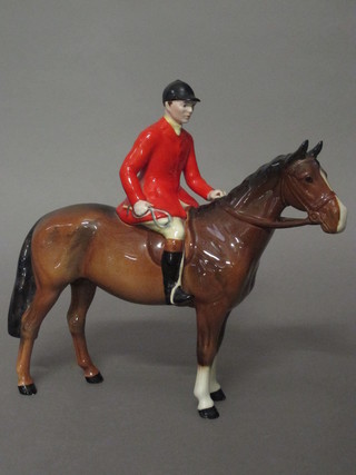 A Beswick figure of a huntsman with red coat