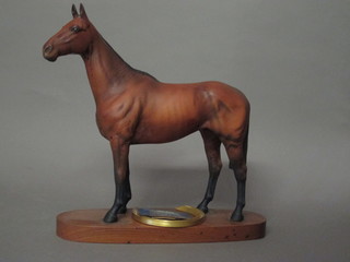 A Beswick figure of Arkle, raised on an oval wooden base,  together with gilt metal racing plate