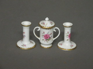 A pair of Coalport Birbeck Rose pattern candlesticks 2", do. jar and cover 2"