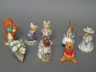 A Royal Doulton Summer bouquet arrangement in the form of a wheelbarrow with flowers, 3 Beswick Beatrix Potter figures with  brown marks to the base, 3 Royal Doulton Beatrix Potter figures  and a Disney figure of Winnie The Pooh