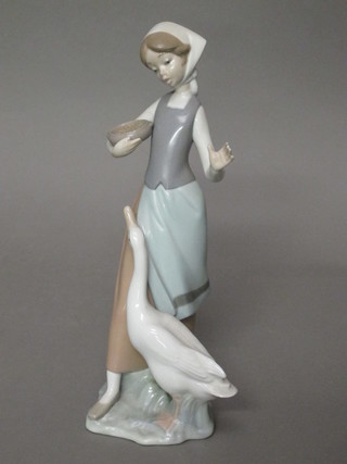 A Lladro figure of a standing girl with Goose 9"