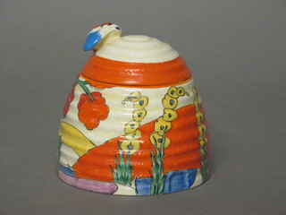 A cylindrical Clarice Cliff preserve jar and cover, the base  marked Bizarre Clarice Cliff, 3"