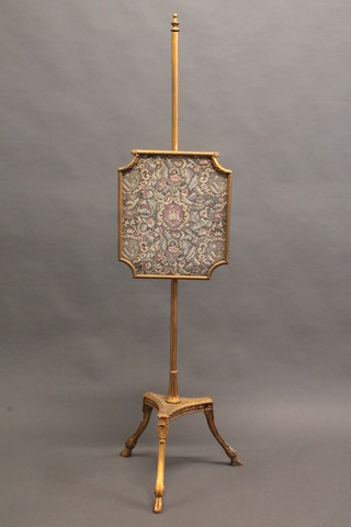 A 19th Century gilt painted pole screen with tapestry banner  raised on a triform base and hoof supports