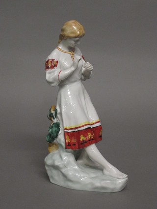 A Polonne porcelain figure of a standing girl with flower,  base marked 6-40 11"