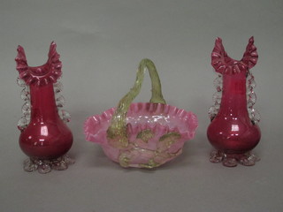A pair of Victorian cranberry glass vases with clear glass handles and a circular pink glass bowl with green glass handle 7"