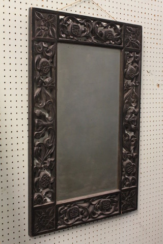 A 19th Century rectangular bevelled plate wall mirror contained  in a carved hardwood frame 19"