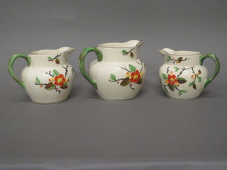 A set of 3 1930's Blossom graduated pottery jugs