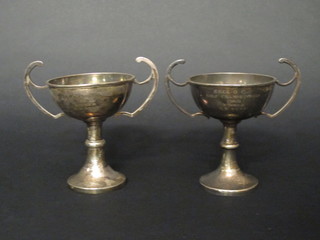 A pair of Sterling silver twin handled trophy cups 10 1/2 ozs