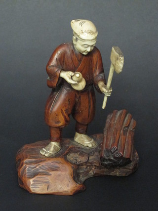An Oriental hardwood and ivory figure of a standing woodsman,  the base signed 7"  ILLUSTRATED