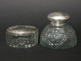 A circular cut glass inkwell with silver plated hinged lid 4" and a  circular glass jar with silver lid 4"