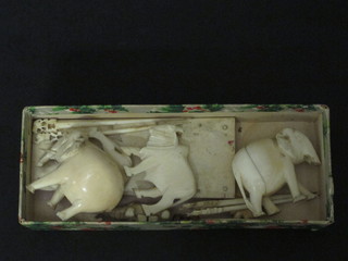 A carved ivory stand, 2 carved ivory figures of elephants, 6  carved ivory cocktail sticks and 5 other carved ivory figures