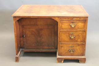 A Queen Anne style walnut kneehole pedestal desk, the kneehole fitted a cupboard, the pedestal fitted a brushing slide above 3  long drawers, raised on bracket feet 39"