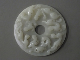 A circular carved Oriental "jade" panel depicting dragons 5"
