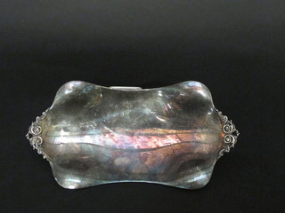A rectangular white metal boat shaped dish, raised on 4 panel supports