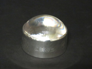 A dome shaped paperweight with silver surround, marked with Jersey shields