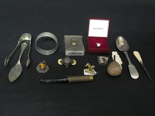 A silver spoon, a silver butter knife, do. napkin ring and a small collection of curios