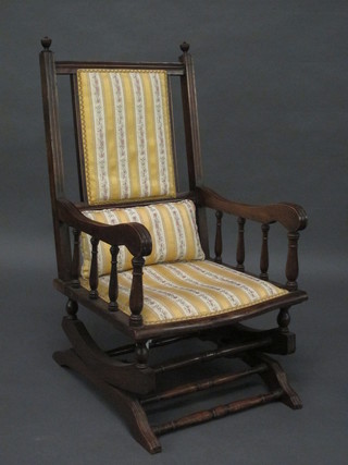 A mahogany framed American rocking armchair