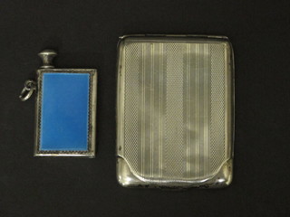 A silver match slip with engine turned decoration, Birmingham 1923, together with a white metal and blue enamelled spirit  lighter