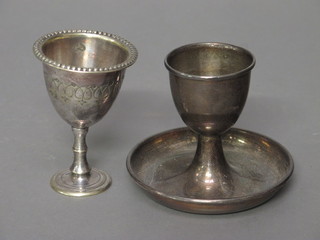 A silver egg cup Sheffield 1935 2 ozs and a plated egg cup
